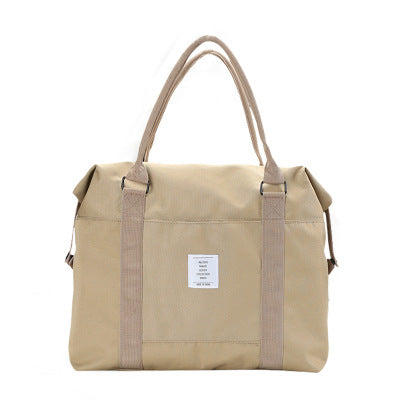 Beige tote bag with brown straps on a white background