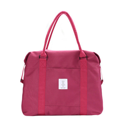 Burgundy handbag with red straps on a white background
