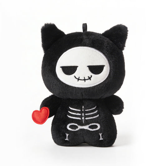 Black plush toy called Koko the skeleton with skeleton design and red heart on a white background