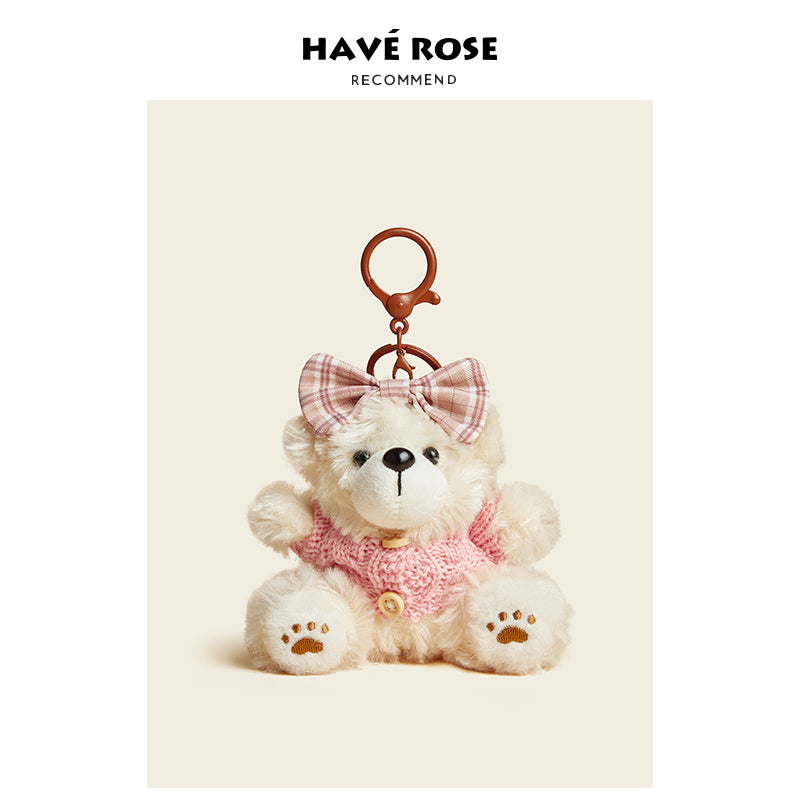 Teddy bear keychain with pink bow and sweater on a beige background, branded 'Have Rose'.