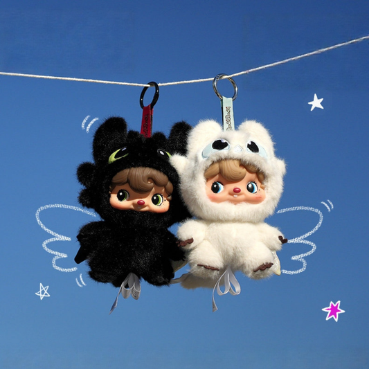 Two cute Poukapouka plush toys, one black and one white.