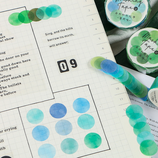 Green and blue washi tape with adhesive dots on a planner page.