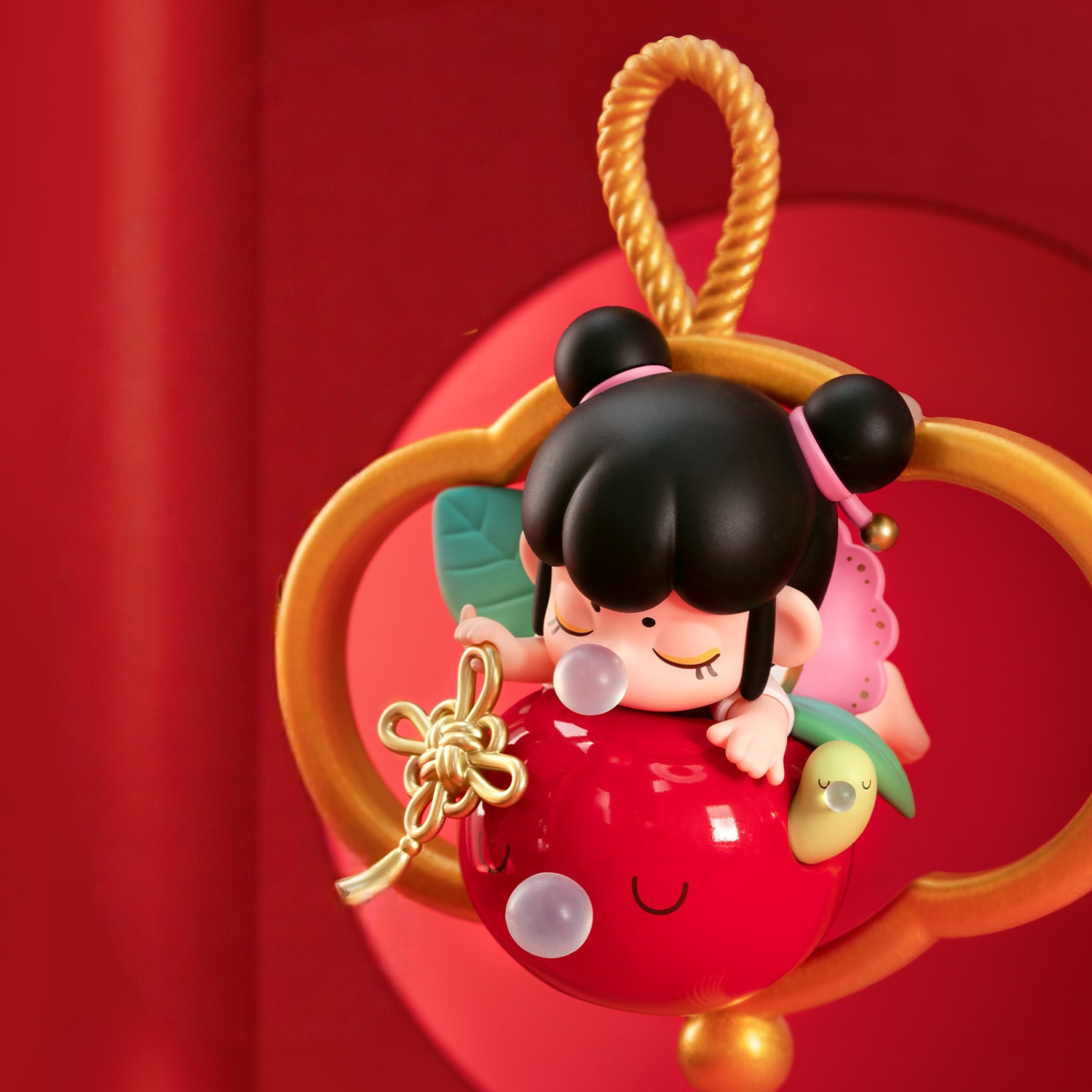 Cute Keep Well Nanci with a big red apple and a golden Chinese knot