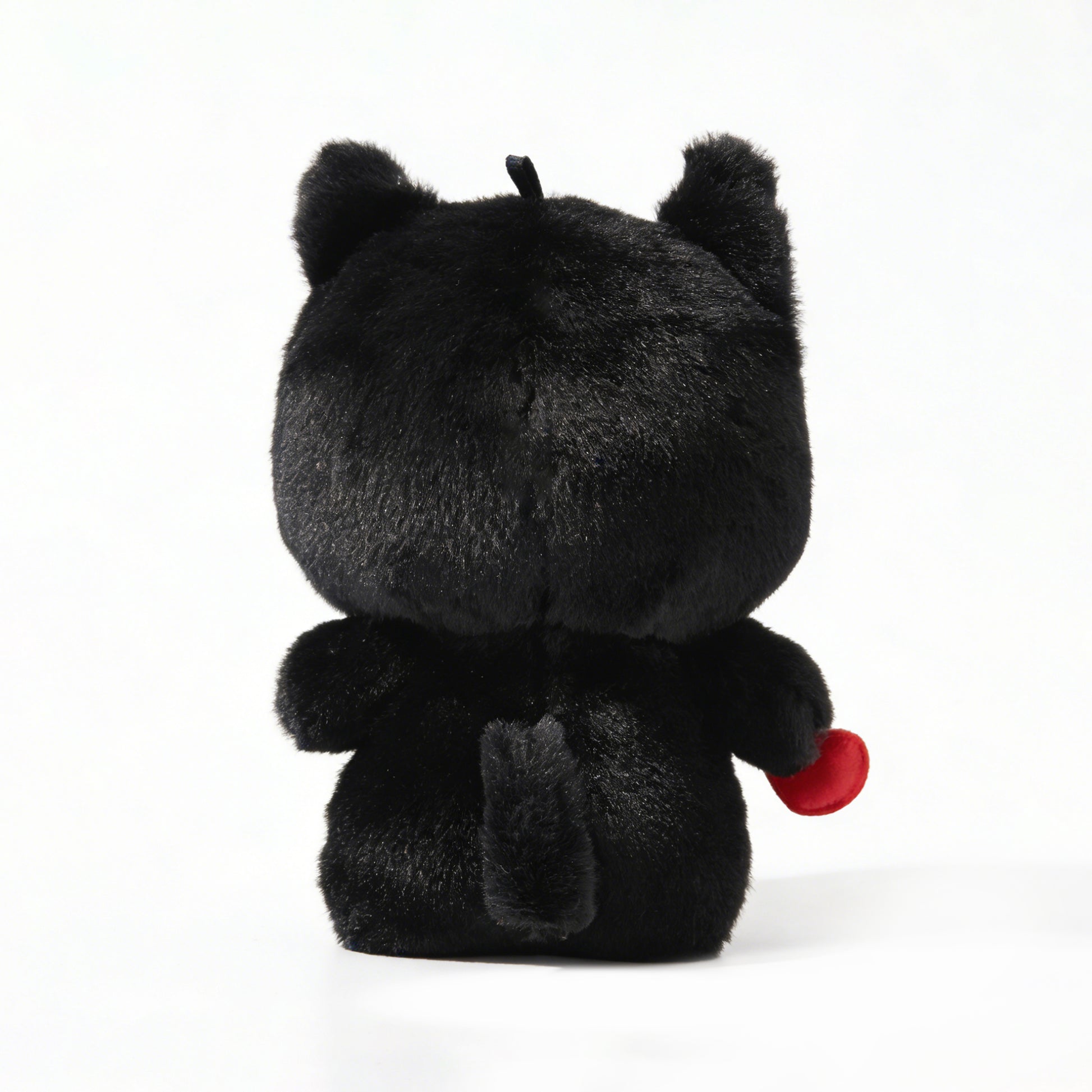 Black plush toy  called Koko the skeleton with red heart on a white background