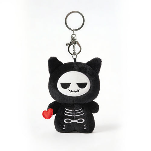 Black skeleton plush keychain called Koko the skeleton with red heart on a white background