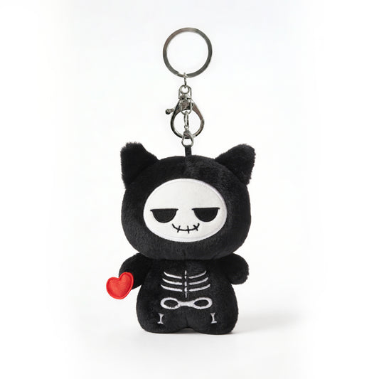 Black skeleton plush keychain called Koko the skeleton with red heart on a white background