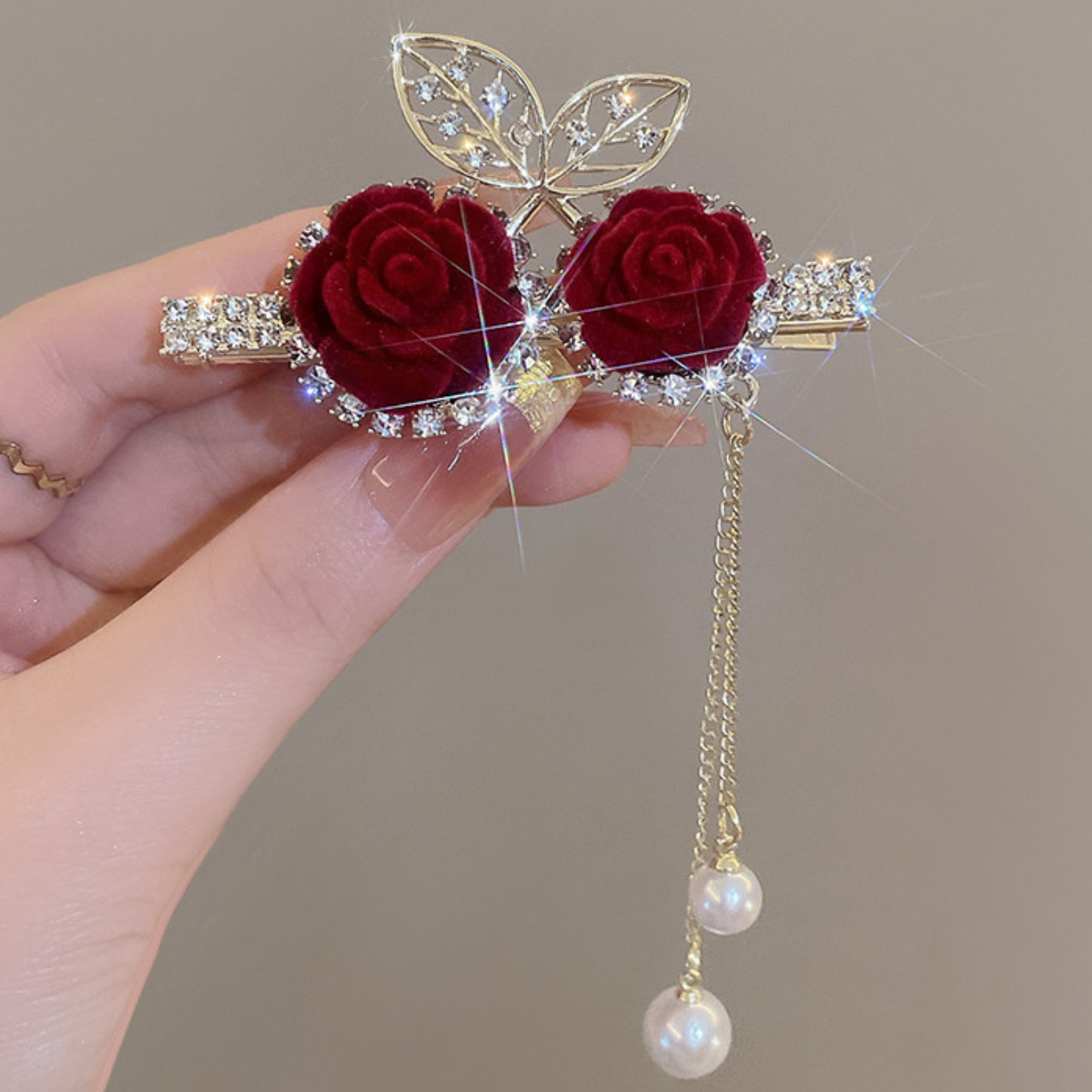 Decorative brooch with red roses, gold leaves, and pearl pendants. Beautiful and Classic