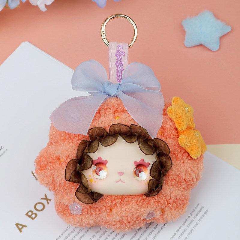 Plush keychain with a cartoon character face on an open book with a pink background  Lovely Emma Floral Seasons Series Blind Box