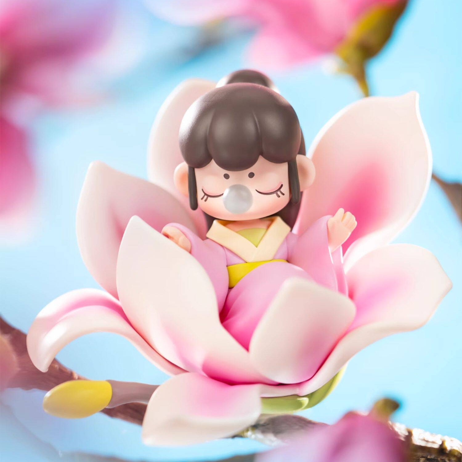 Cute Magnolia wears a traditional pink hanfu, seated within a large pink magnolia flower.