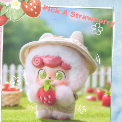 Q Kid “Pick A Strawberry” plush toy holding a juicy berry – a fresh and charming addition to your everyday bag.