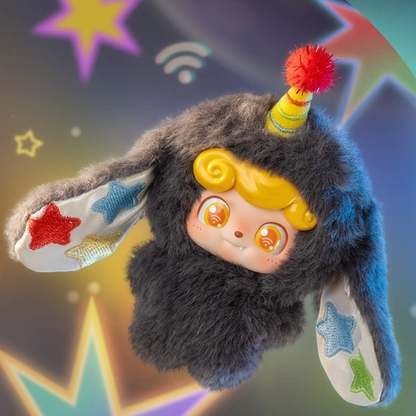 Adorably fluffy “Intuition” mini plush Q kid in deep charcoal tones with colourful star accents — a quirky yet comforting companion that encourages you to trust your instincts and carry a little luck with you wherever you go.