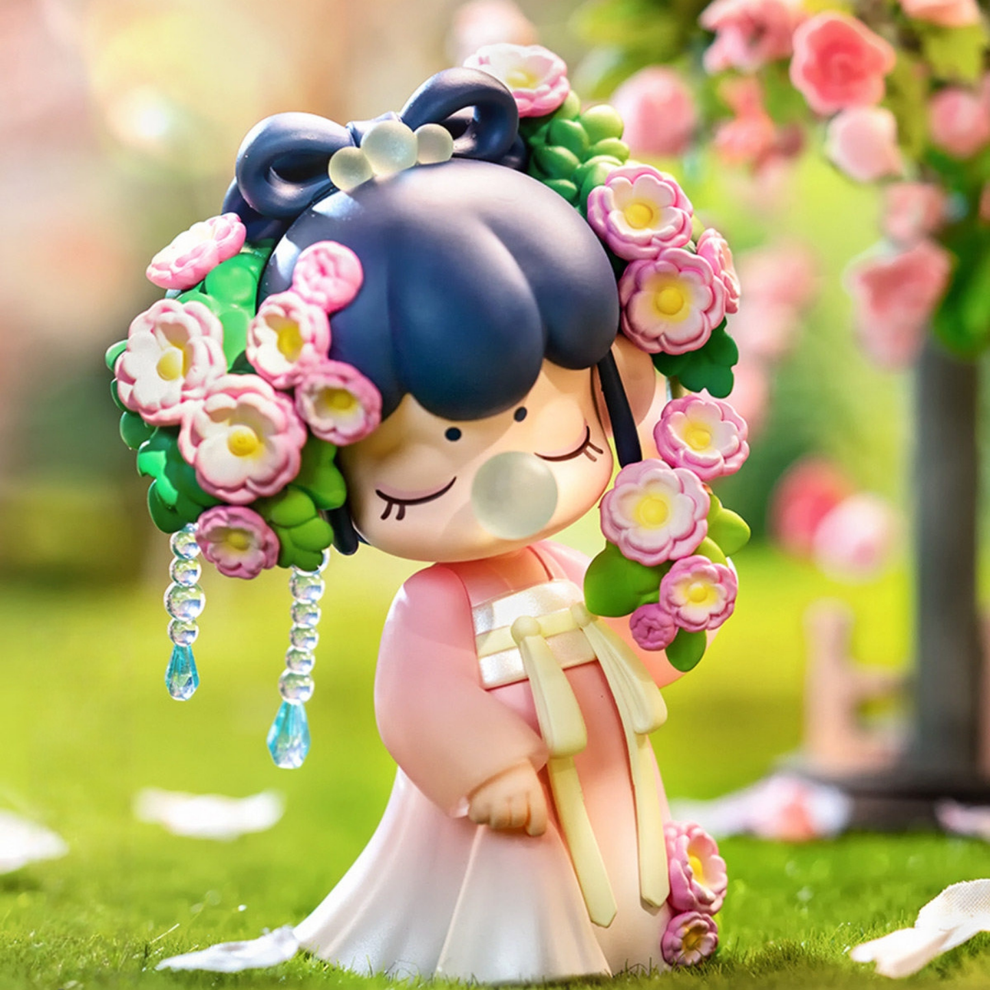 Rose Sniffing Nanci figure, girl in soft pink hanfu holding a flower wreath, surrounded by roses.