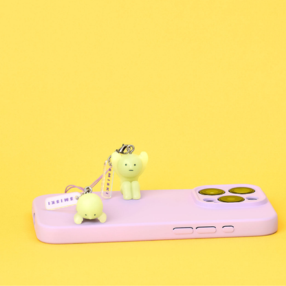 One SMISKI is lying on the phone, another one is sitting on it. SMISKI can be used as a phone chain